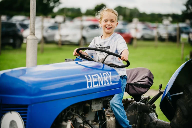 A girl on Henry the farm tractor